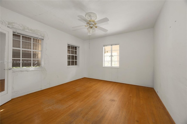 unfurnished room with wood finished floors and a ceiling fan