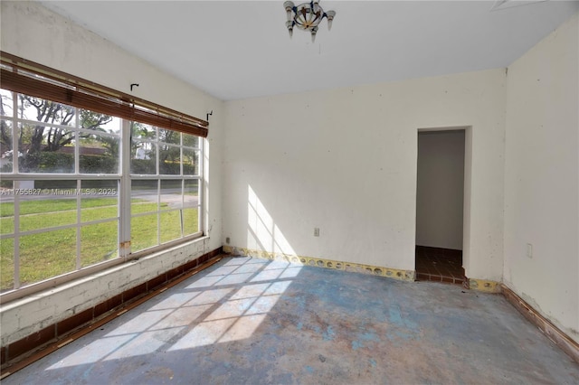 empty room with unfinished concrete flooring