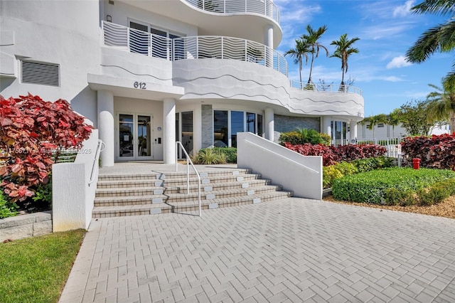 exterior space featuring french doors and stucco siding