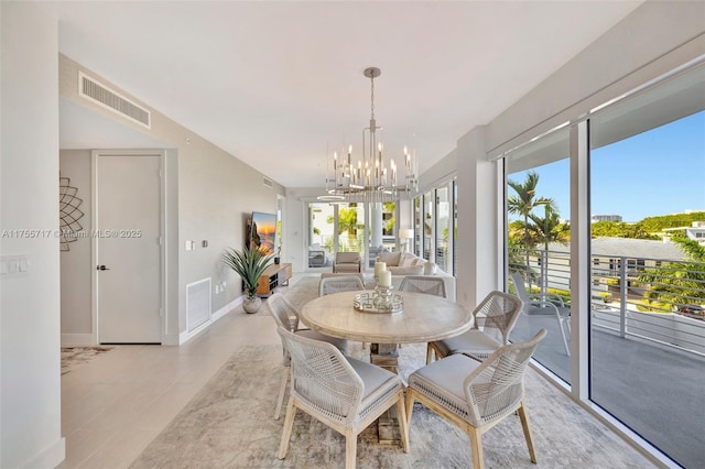 dining area with a chandelier, visible vents, and baseboards