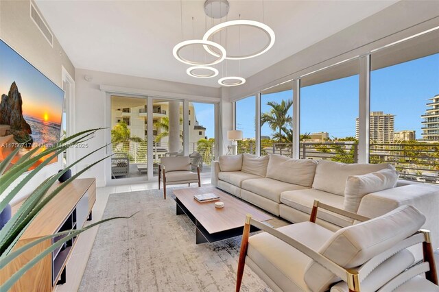 sunroom / solarium featuring a healthy amount of sunlight, visible vents, and a city view