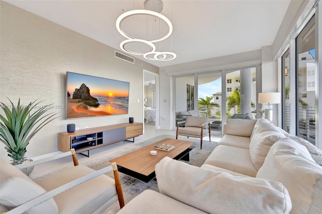 living room featuring visible vents and a chandelier