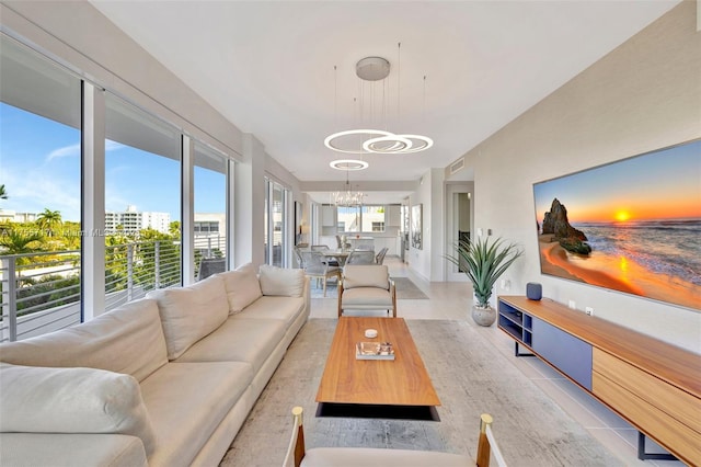 tiled living area featuring plenty of natural light, visible vents, and a notable chandelier