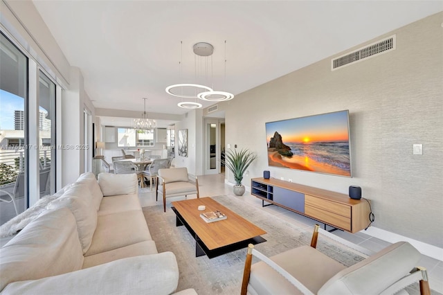 living room with visible vents and a notable chandelier