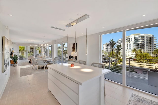 kitchen with a center island, open floor plan, modern cabinets, and a healthy amount of sunlight