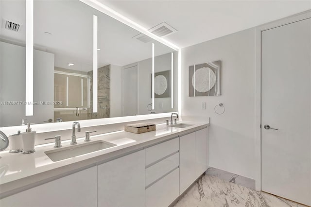 full bath with marble finish floor, a shower stall, visible vents, and a sink