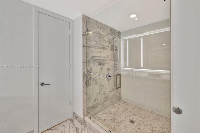 bathroom with marble finish floor and a marble finish shower