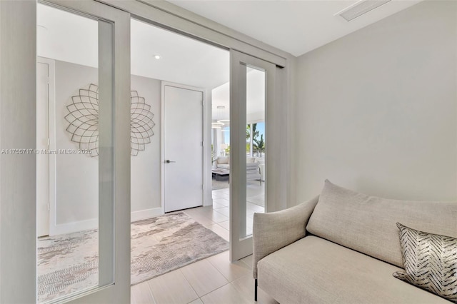 living area with light tile patterned floors and visible vents