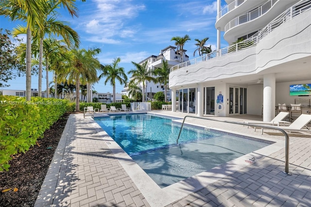 pool with a patio and fence