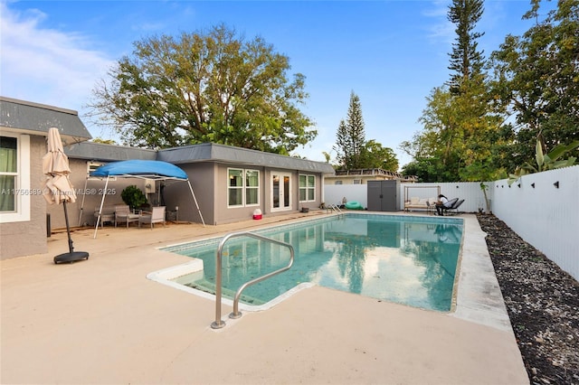 view of pool featuring a patio, a fenced backyard, and a fenced in pool