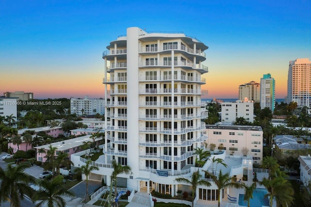 property at dusk featuring a view of city