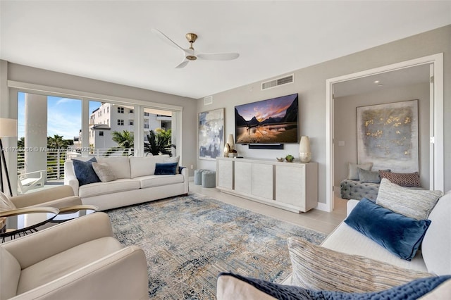 tiled living area with visible vents and ceiling fan