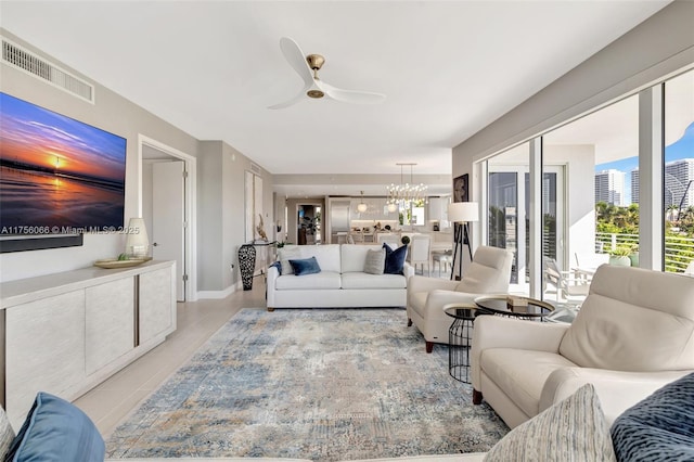 living room featuring visible vents and ceiling fan with notable chandelier