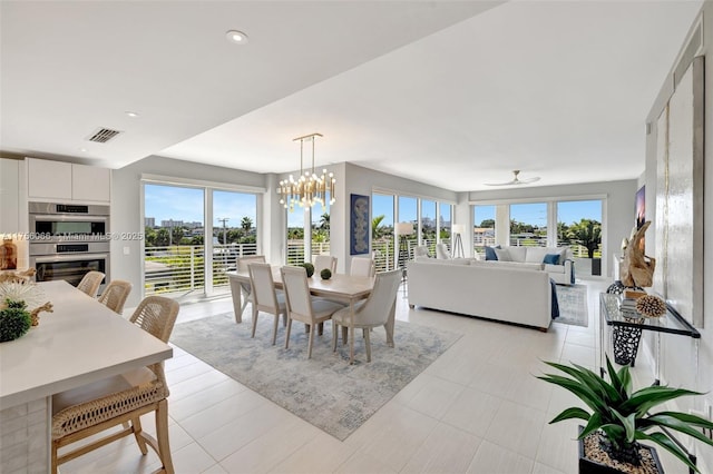 dining room with ceiling fan with notable chandelier, visible vents, and recessed lighting