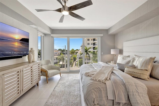 bedroom featuring light tile patterned floors, a ceiling fan, and access to outside