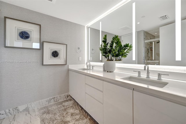 full bath featuring visible vents, marble finish floor, a shower stall, and a sink