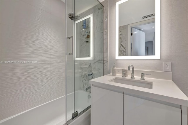 full bath featuring visible vents, enclosed tub / shower combo, and vanity