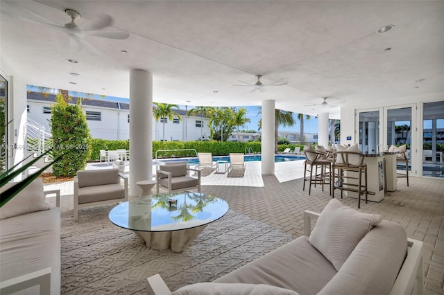 view of patio / terrace featuring an outdoor pool, an outdoor hangout area, and outdoor dining space