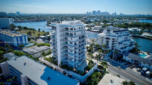 birds eye view of property with a view of city and a water view