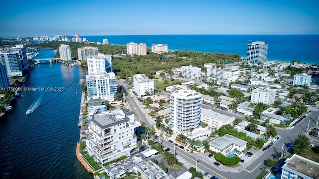 drone / aerial view featuring a city view and a water view