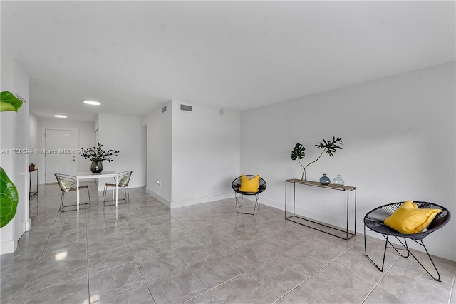 unfurnished room with baseboards and visible vents