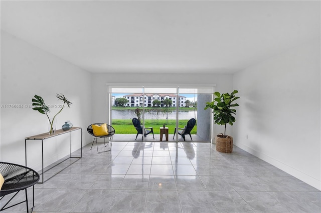 sitting room with tile patterned flooring and baseboards