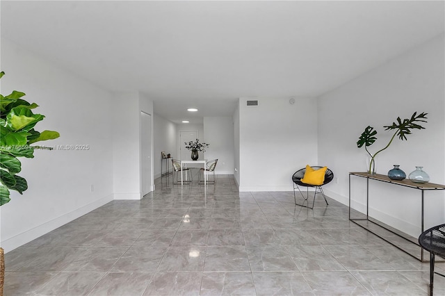 unfurnished room featuring visible vents and baseboards