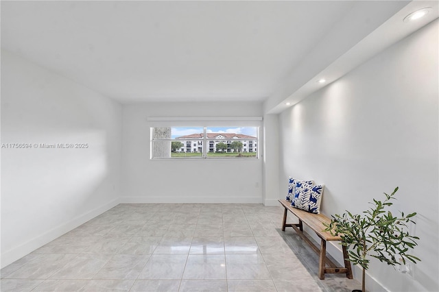 spare room with recessed lighting and baseboards