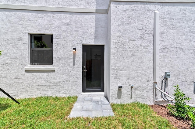 entrance to property with stucco siding