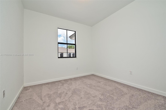 carpeted empty room with baseboards