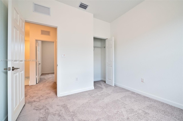 unfurnished bedroom with light carpet and visible vents