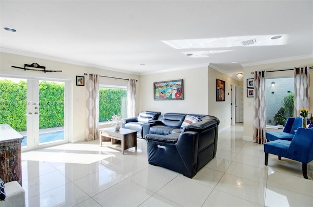 living area with baseboards, visible vents, crown molding, french doors, and light tile patterned flooring