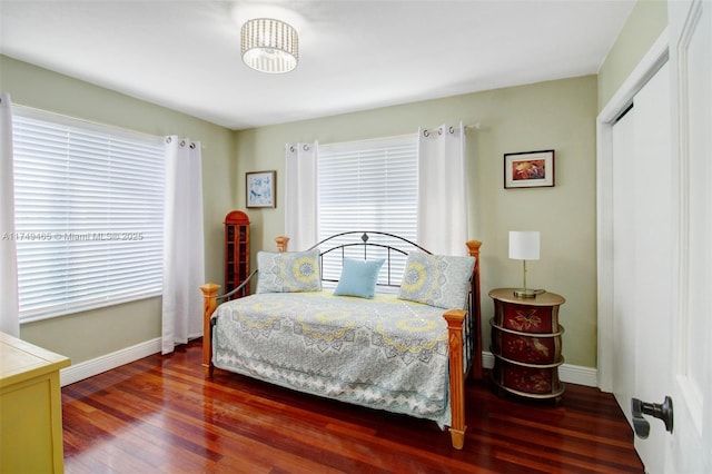 bedroom featuring wood finished floors and baseboards