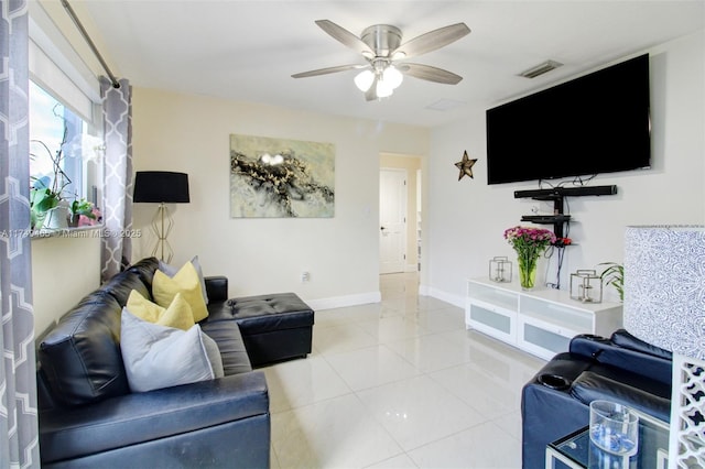 living room with a ceiling fan, light tile patterned flooring, visible vents, and baseboards