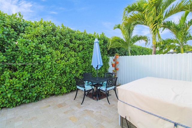 view of patio featuring outdoor dining area and fence