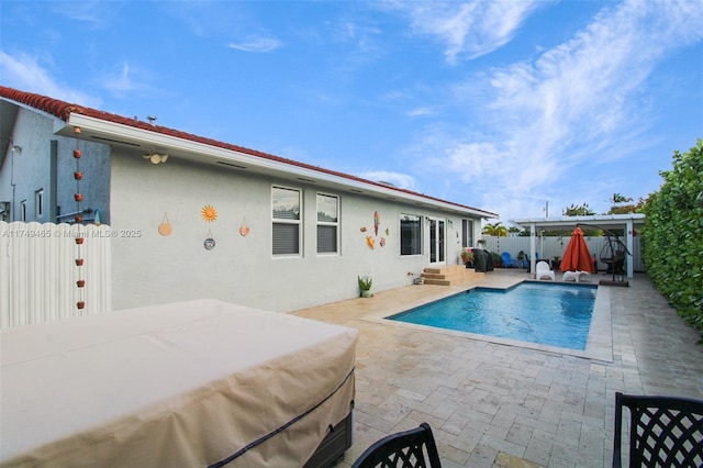 view of swimming pool featuring entry steps, a patio area, and a fenced backyard