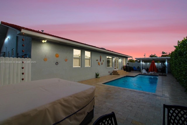 view of swimming pool with entry steps, a fenced backyard, a fenced in pool, and a patio