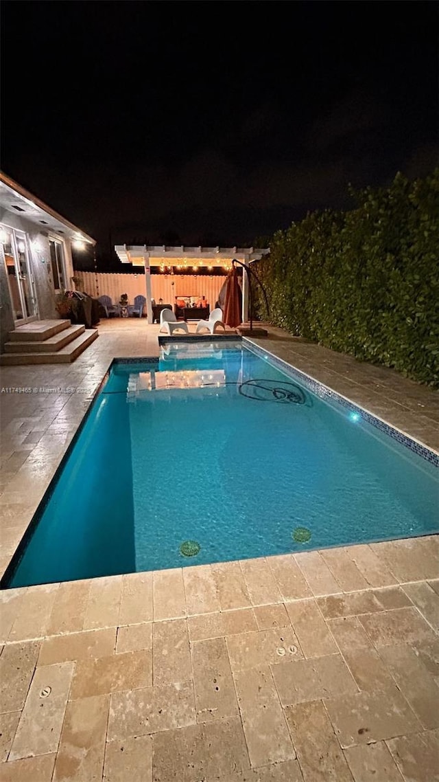 pool at twilight featuring a fenced in pool, a patio area, and fence