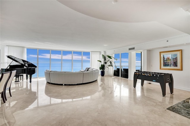 living room featuring marble finish floor, visible vents, and floor to ceiling windows