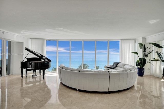 living area featuring a water view and marble finish floor