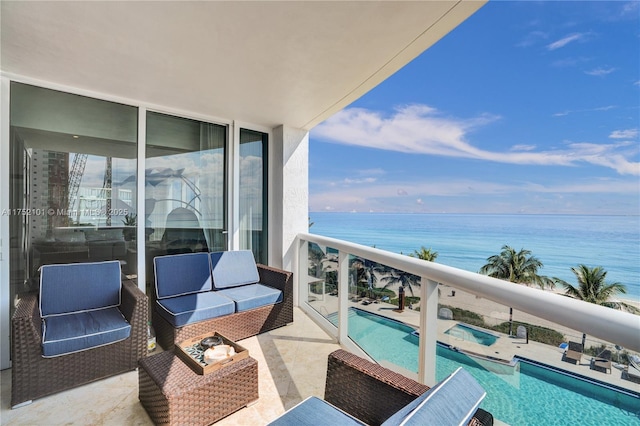 balcony with a water view and an outdoor living space