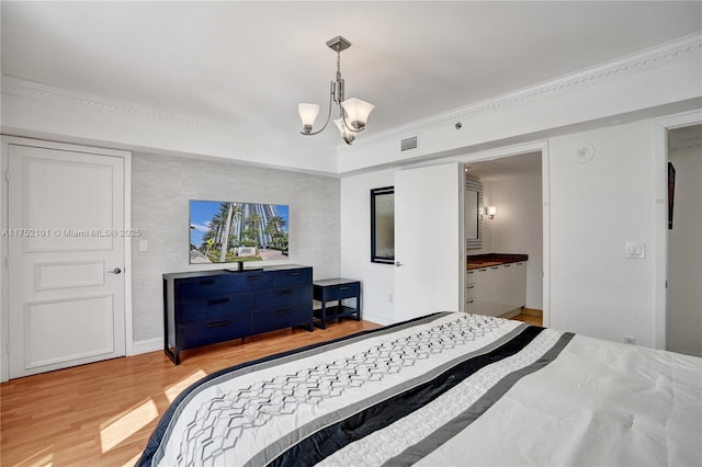 bedroom featuring baseboards, visible vents, crown molding, light wood-type flooring, and a notable chandelier