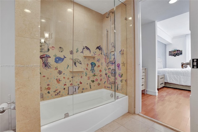 full bath featuring bath / shower combo with glass door, connected bathroom, and tile patterned floors