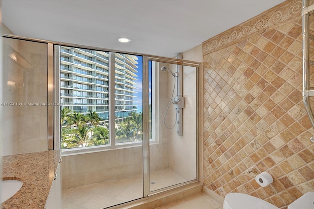 full bath with toilet, a shower stall, tile patterned flooring, and recessed lighting