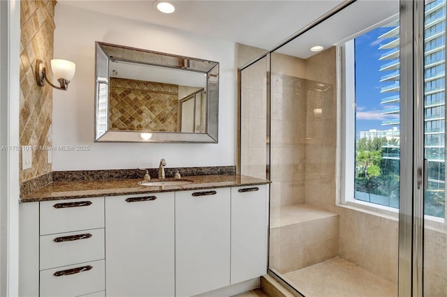 full bathroom featuring a stall shower, vanity, and recessed lighting