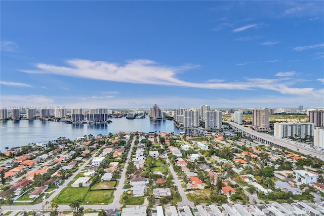 drone / aerial view featuring a water view and a view of city