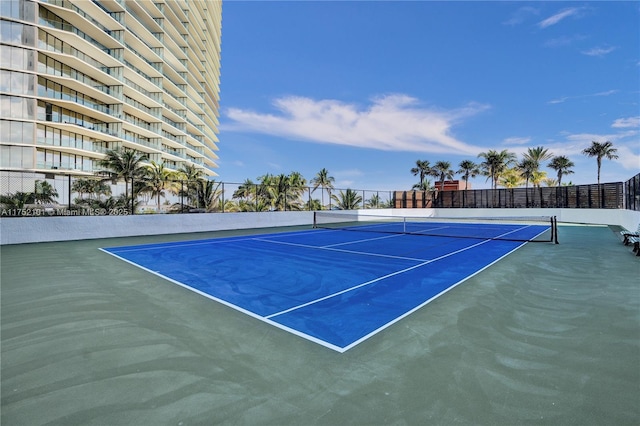 view of tennis court featuring fence