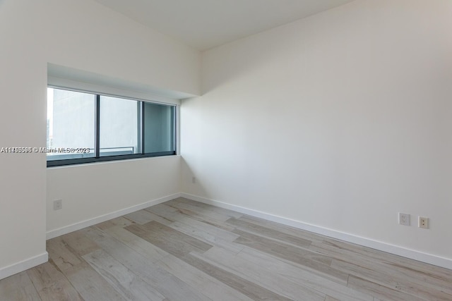 empty room featuring light wood-style floors and baseboards