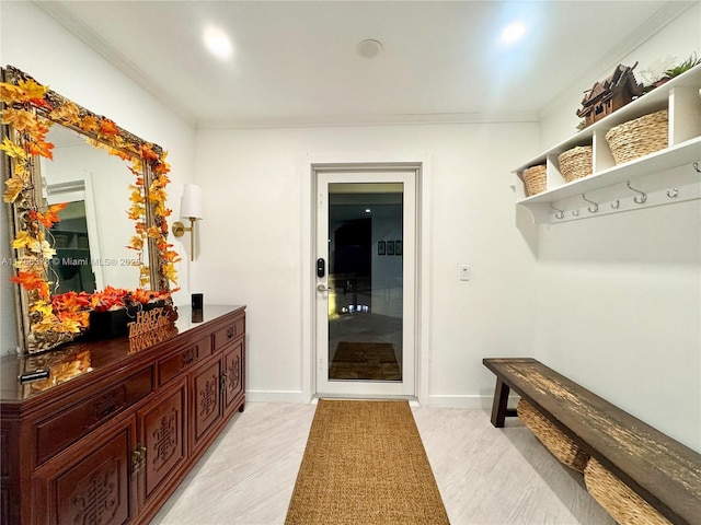 mudroom with ornamental molding and baseboards