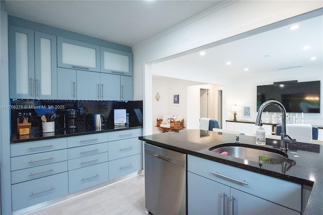 kitchen featuring dark stone counters, glass insert cabinets, backsplash, stainless steel dishwasher, and a sink